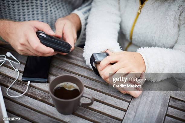 high angle midsection of caretaker and disabled woman using technologies at table - router stock pictures, royalty-free photos & images