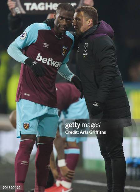 Billy McKinlay of West Ham United speaks with Pedro Obiang during the Premier League match between Huddersfield Town and West Ham United at John...