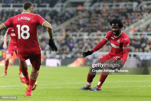 Jordan Ayew of Swansea City passes the ball to team mate Wilfried Bony during the Premier League match between Newcastle United and Swansea City at...