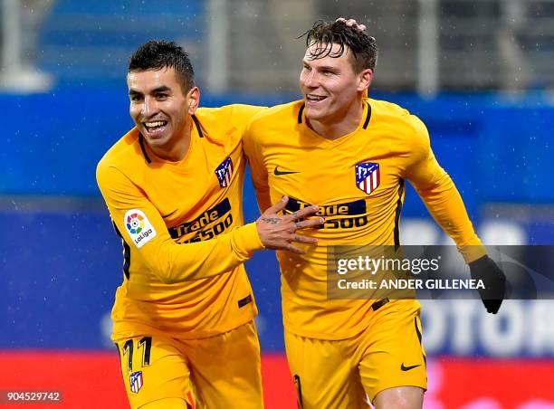 Atletico Madrid's French forward Kevin Gameiro is congtratulated by teammate Argentinian forward Angel Correa after scoring his team's first goal...