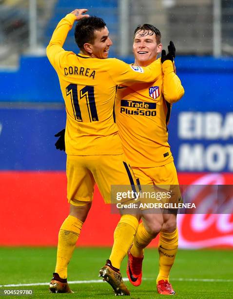 Atletico Madrid's French forward Kevin Gameiro is congtratulated by teammate Argentinian forward Angel Correa after scoring his team's first goal...