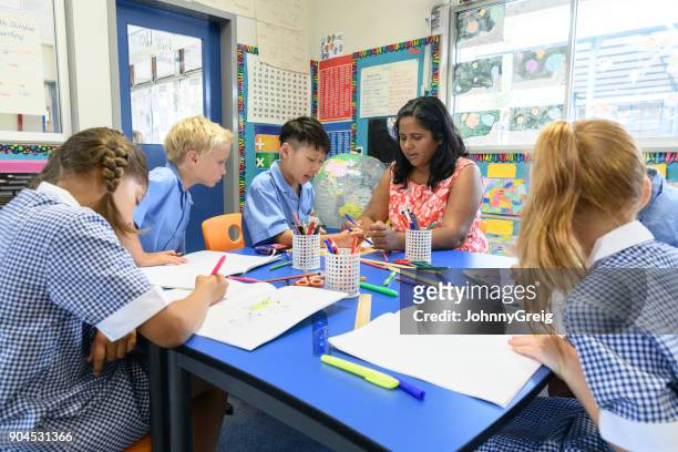 group of multi racial school children in classroom with their teacher - sydney school stock pictures, royalty-free photos & images