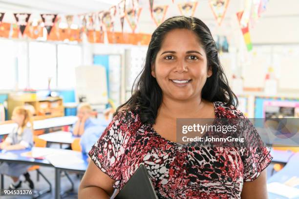 portrait of aboriginal woman in school classroom - teacher studio portrait stock pictures, royalty-free photos & images