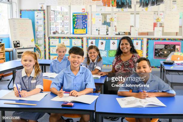 portrait of five primary school children in classroom with their teacher - native korean stock pictures, royalty-free photos & images