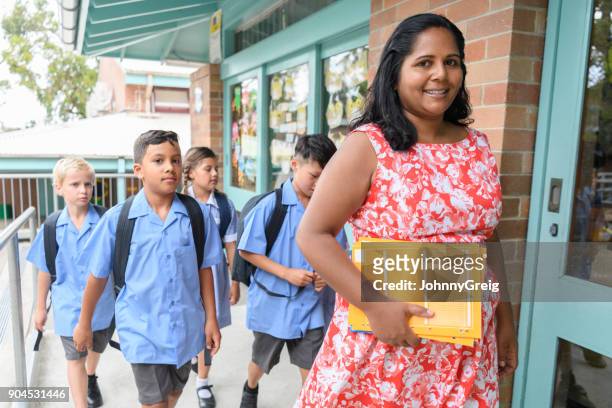 school teacher and pupils arriving at school - sydney school stock pictures, royalty-free photos & images
