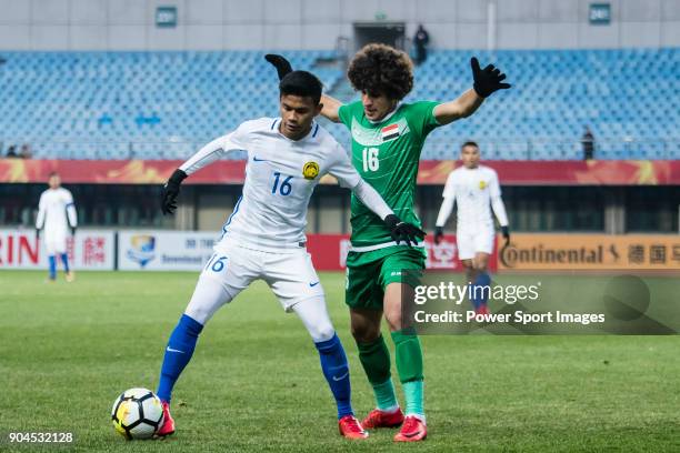 Danial Amier Norhisham of Malaysia fights for the ball with Safaa Hadi of Iraq during the AFC U23 Championship China 2018 Group C match between Iraq...