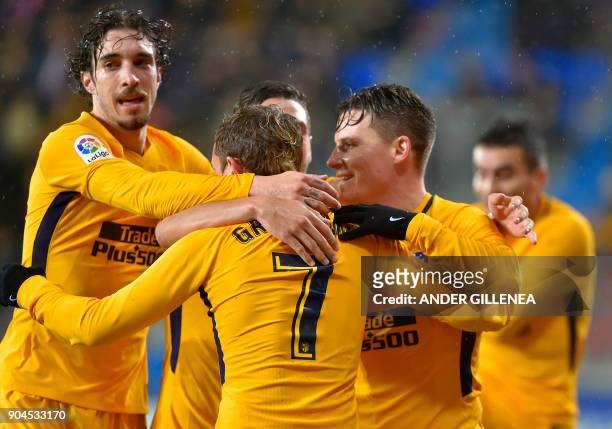 Atletico Madrid players celebrate after French forward Kevin Gameiro scored his team's first goal during the Spanish league football match between SD...