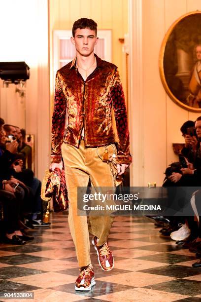 Model presents a creation for fashion house Versace during the Men's Fall/Winter 2019 fashion shows in Milan, on January 13, 2018. / AFP PHOTO /...