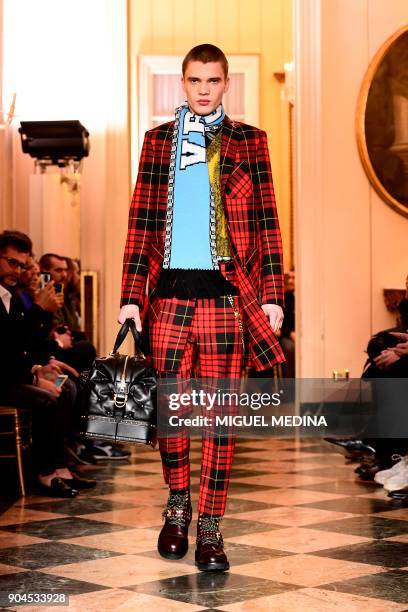 Model presents a creation for fashion house Versace during the Men's Fall/Winter 2019 fashion shows in Milan, on January 13, 2018. / AFP PHOTO /...