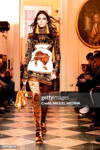 Model presents a creation for fashion house Versace during the Men's Fall/Winter 2019 fashion shows in Milan, on January 13, 2018. / AFP PHOTO /...