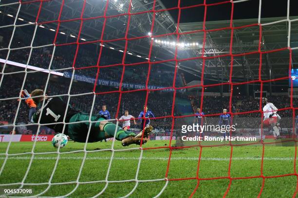 Goalkeeper Ralf Faehrmann of Schalke saves a penalty against Jean-Kevin Augustin of Leipzig during the Bundesliga match between RB Leipzig and FC...