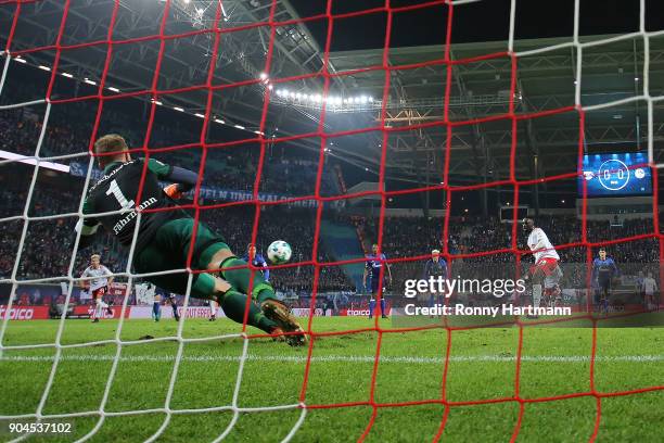 Goalkeeper Ralf Faehrmann of Schalke saves a penalty against Jean-Kevin Augustin of Leipzig during the Bundesliga match between RB Leipzig and FC...