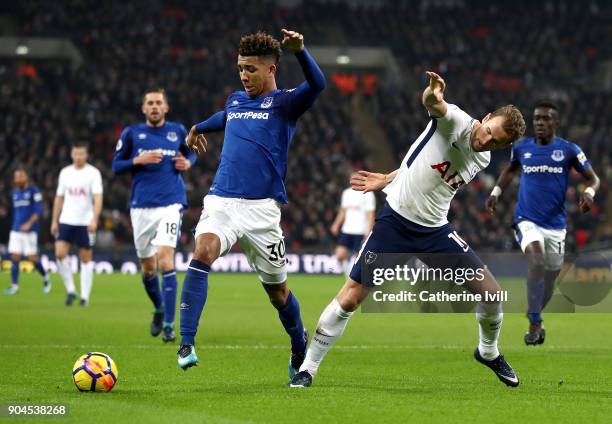 Mason Holgate of Everton is challenged by Harry Kane of Tottenham Hotspur during the Premier League match between Tottenham Hotspur and Everton at...