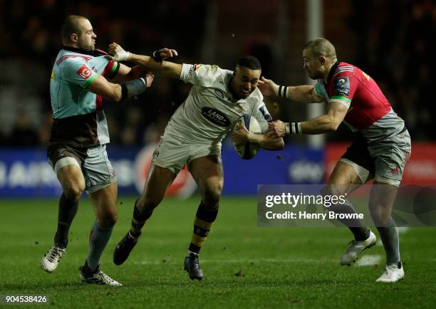 Marcus Watson of Wasps tackled by Ross Chisholm and Mike Brown of Harlequins during the European Rugby Champions Cup match between Harlequins and...