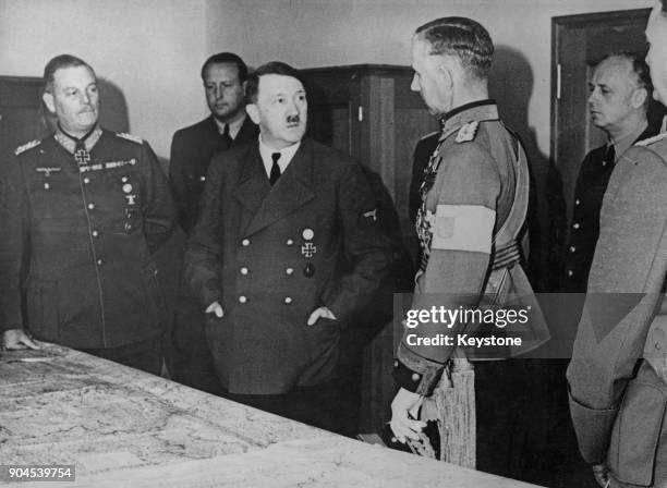 German Chancellor Adolf Hitler receives Finnish officer Lieutenant General Harald Ohquist at his headquarters, circa 1942. On the left is German...
