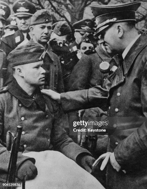 German Chancellor Adolf Hitler meets a wounded soldier during Operation Barbarossa, the Axis invasion of the Soviet Union during World War II, 1941.