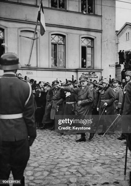 German Chancellor Adolf Hitler gives the Nazi salute whilst inspecting German troops in the Theatre Square in Memel, Germany , March 1939. The troops...