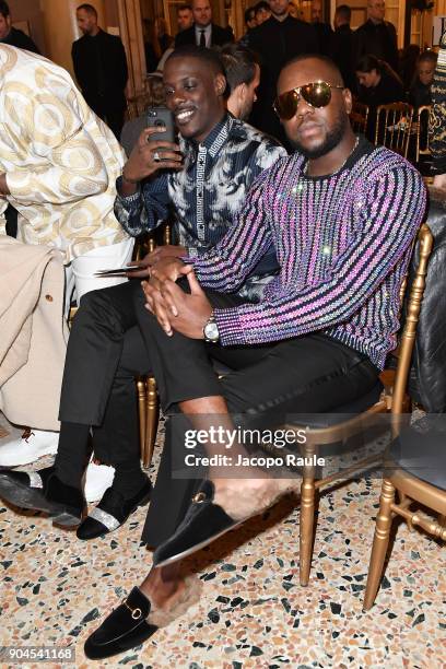 Maître Gims and a guest attend the Versace show during Milan Men's Fashion Week Fall/Winter 2018/19 on January 13, 2018 in Milan, Italy.