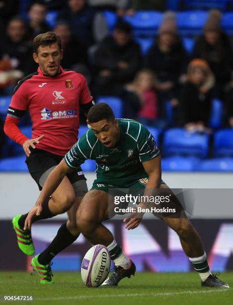 Ben Loader of London Irish picks up the ball on his way to scoring his team's first try of the game during the European Rugby Challenge Cup between...