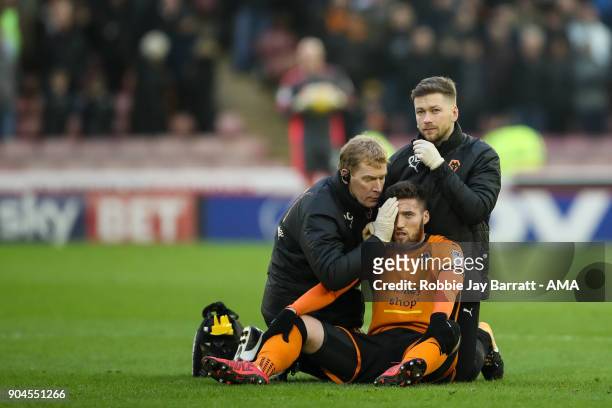 Matt Doherty of Wolverhampton Wanderers receives treatment during the Sky Bet Championship match between Barnsley and Wolverhampton at Oakwell...