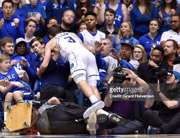 Grayson Allen of the Duke Blue Devils crashes into the stands as he dives for a loose ball during their against the Wake Forest Demon Deacons game at...