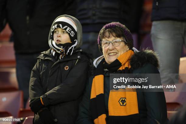 Young fan and and elderly fan of Wolverhampton Wanderers look onduring the Sky Bet Championship match between Barnsley and Wolverhampton at Oakwell...