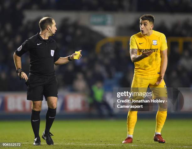 Preston's Referee Jeremy Simpson shows a yellow card to Preston's Jordan Hugill during the Sky Bet Championship match between Millwall and Preston...
