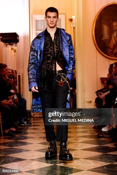 Model presents a creation for fashion house Versace during the Men's Fall/Winter 2019 fashion shows in Milan, on January 13, 2018. / AFP PHOTO /...