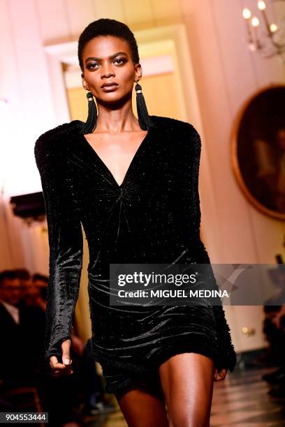 Model presents a creation for fashion house Versace during the Men's Fall/Winter 2019 fashion shows in Milan, on January 13, 2018. / AFP PHOTO /...