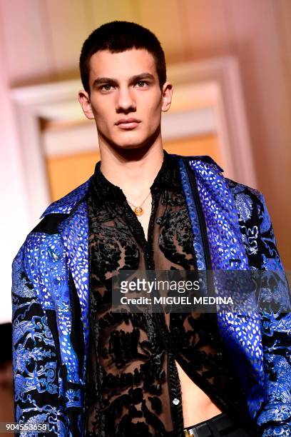 Model presents a creation for fashion house Versace during the Men's Fall/Winter 2019 fashion shows in Milan, on January 13, 2018. / AFP PHOTO /...