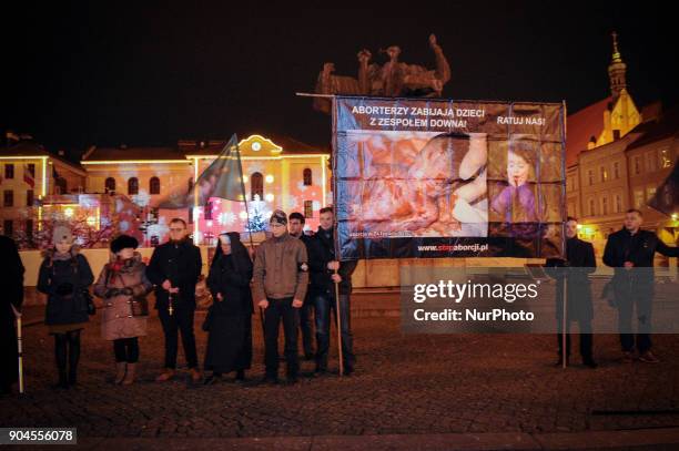 Men are seen holding a banner depicting an aborted foetus on January 13, 2018. On Saturday a rosary was held on the Old Market Square for the renewal...