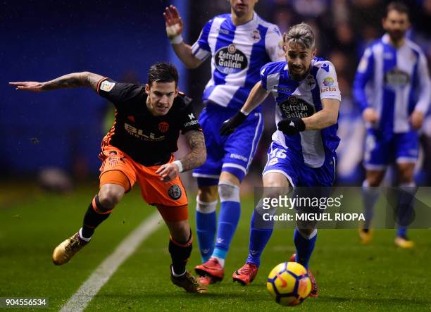 Valencia's Spanish forward Santi Mina vies with Deportivo La Coruna's Portuguese defender Luisinho during the Spanish league football match between...