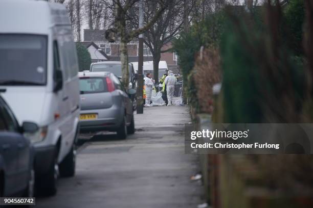 Forensic technicians work outside a home in Matlock Road, Reddish, after a body was found in a back garden on January 10, 2018 in Manchester,...