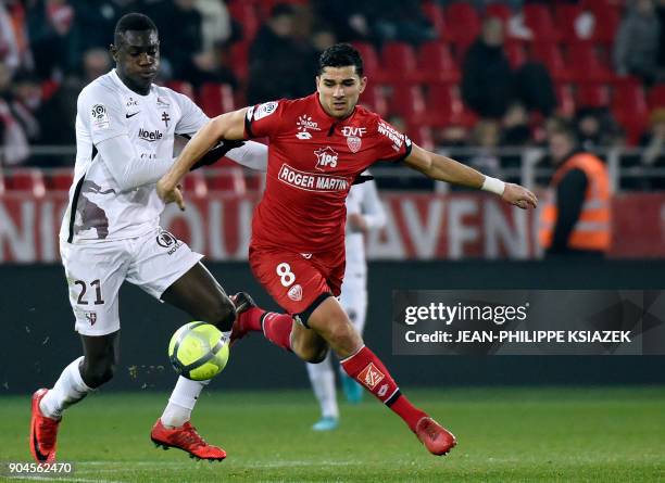 Metz' French defender Moussa Niakhate vies with Dijon's French-Algerian midfielder Mehdi Abeid during the French L1 football match Dijon vs Metz on...