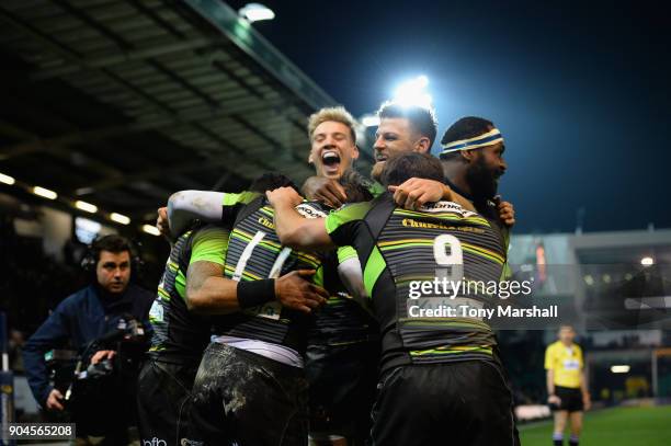 Ben Foden of Northampton Saints celebrates scoring a try with his team mates during the European Rugby Champions Cup match between Northampton Saints...