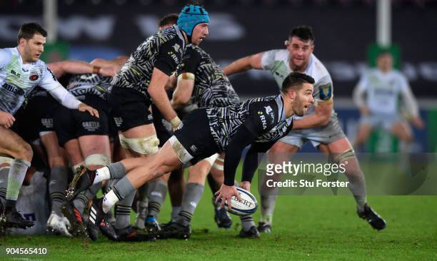 Ospreys player Rhys Webb passes from a scrum during the European Rugby Champions Cup match between Ospreys and Saracens at Liberty Stadium on January...