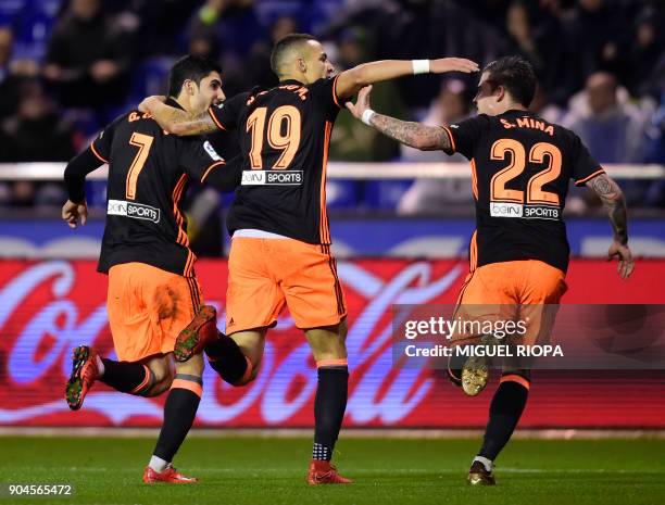 Valencia's Portuguese forward Goncalo Guedes celebrates a goal with Valencia's Spanish forward Rodrigo Moreno and Valencia's Spanish forward Santiago...