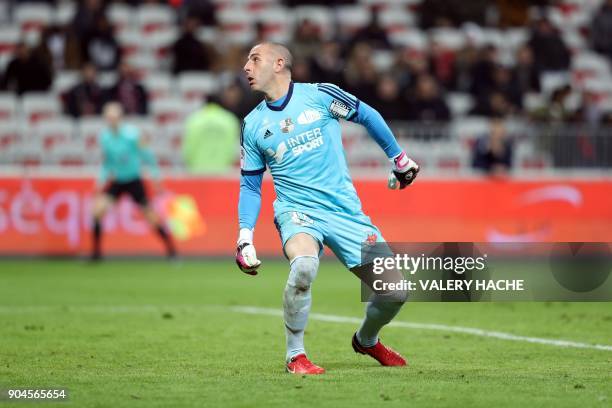 Amiens' French goalkeeper Jean-Christophe Bouet looks at the ball as he concedes a goal during the French L1 football match Nice vs Amiens on January...