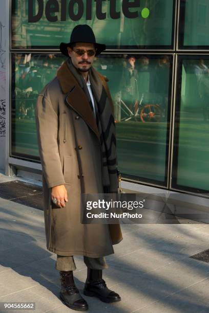 Guest is seen on the set of the Armani Advertising Campaign street style during Milan Men's Fashion Week Fall/Winter 2018/19 on January 13, 2018 in...