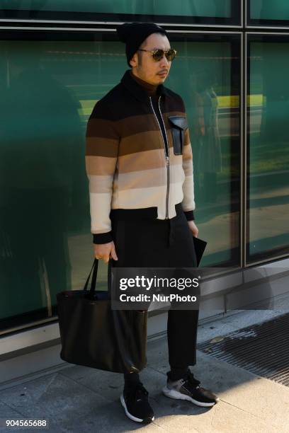 Guest is seen on the set of the Armani Advertising Campaign street style during Milan Men's Fashion Week Fall/Winter 2018/19 on January 13, 2018 in...