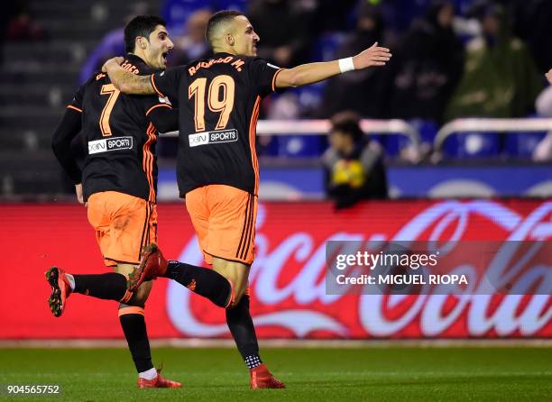 Valencia's Portuguese midfielder Goncalo Guedes celebrates a goal with teammate Valencia's Spanish forward Rodrigo Moreno during the Spanish league...