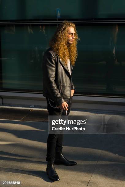 Guest is seen on the set of the Armani Advertising Campaign street style during Milan Men's Fashion Week Fall/Winter 2018/19 on January 13, 2018 in...