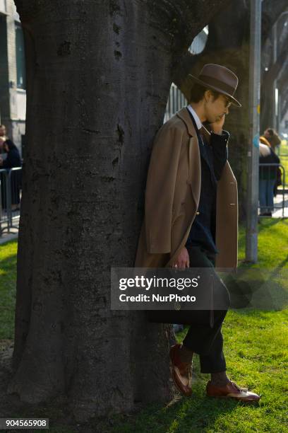 Guest is seen on the set of the Armani Advertising Campaign street style during Milan Men's Fashion Week Fall/Winter 2018/19 on January 13, 2018 in...