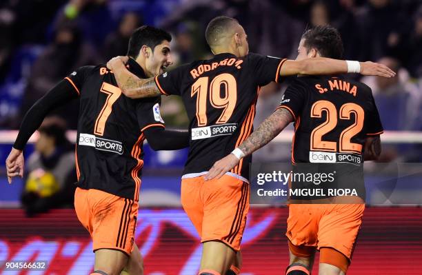 Valencia's Portuguese forward Goncalo Guedes celebrates a goal with Valencia's Spanish forward Rodrigo Moreno and Valencia's Spanish forward Santiago...