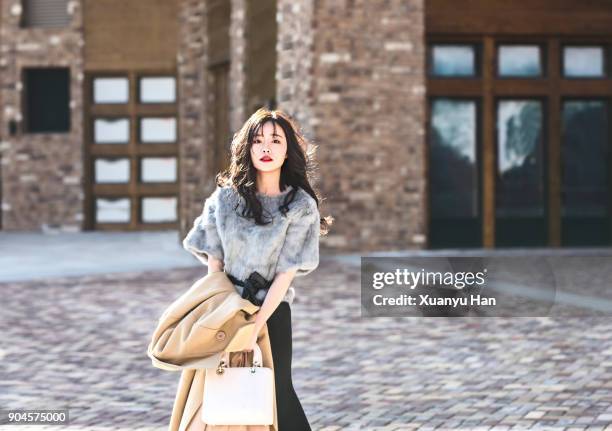 portrait of young woman on street - chinese model bildbanksfoton och bilder