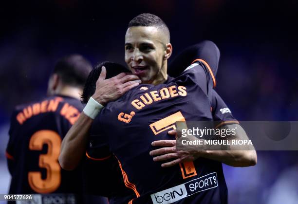 Valencia's Spanish forward Rodrigo Moreno celebrates a goal with teammate Portuguese midfielder Goncalo Guedes during the Spanish league football...