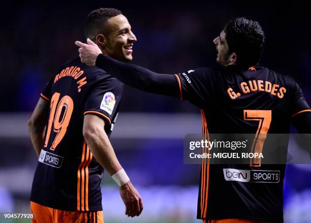 Valencia's Spanish forward Rodrigo Moreno celebrates a goal with teammate Portuguese midfielder Goncalo Guedes during the Spanish league football...