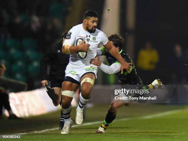 Ben Foden of Northampton Saints tackles Fritz Lee of ASM Clermont Auvergne during the European Rugby Champions Cup match between Northampton Saints...