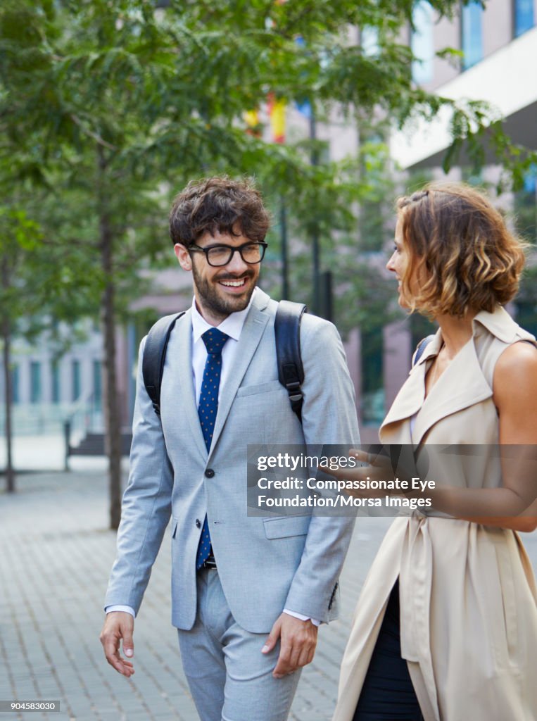 Business people walking and talking outdoors