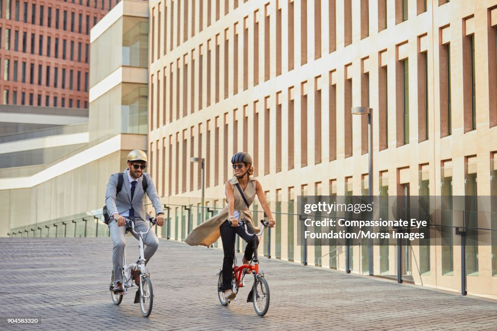 Business people riding bicycles on city street